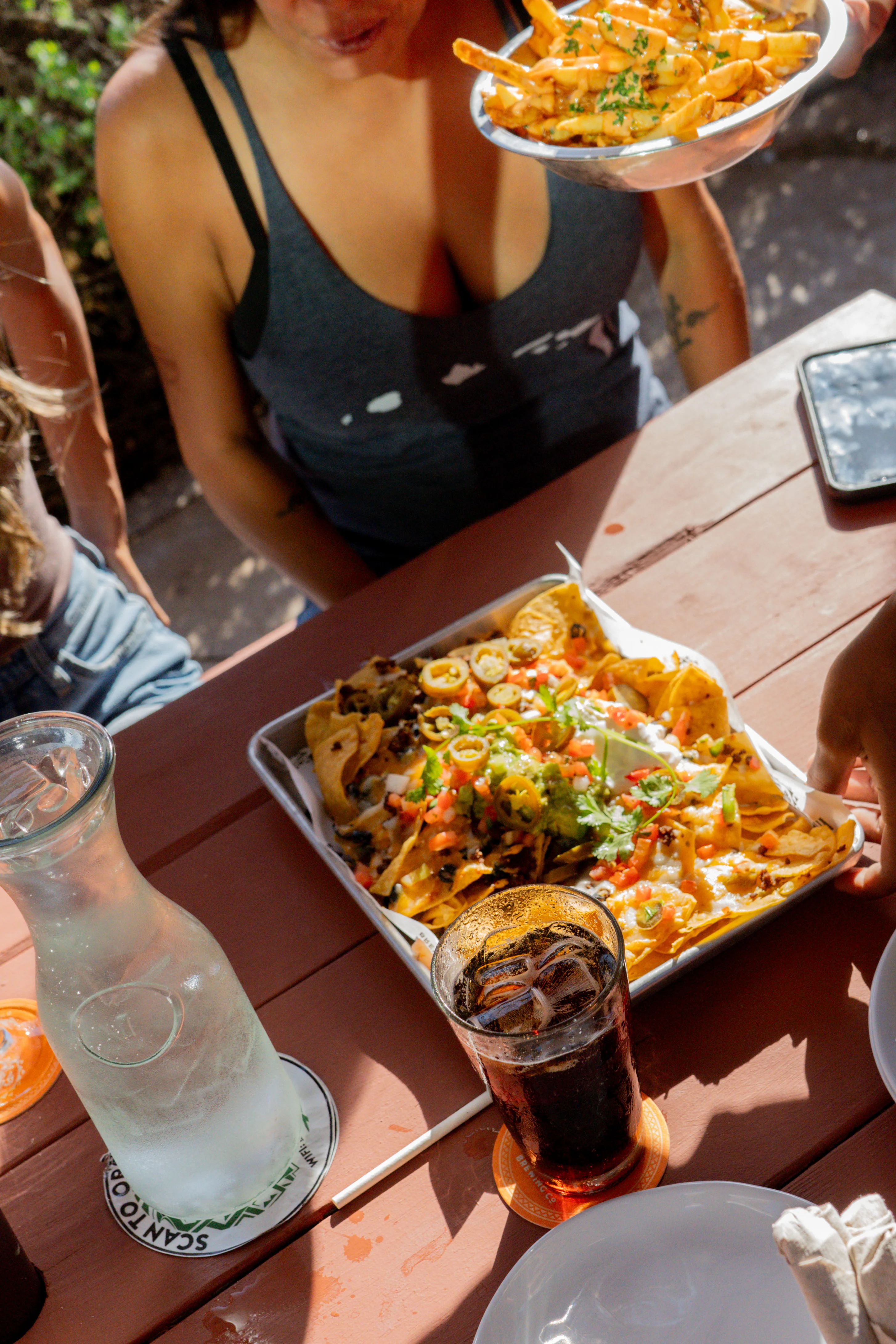 Loaded nachos with toppings in a vibrant outdoor setting