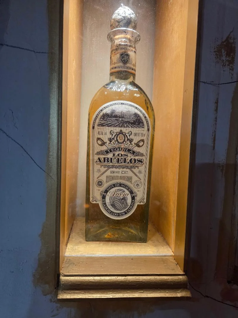 Añejo tequila bottle displayed in a wooden case