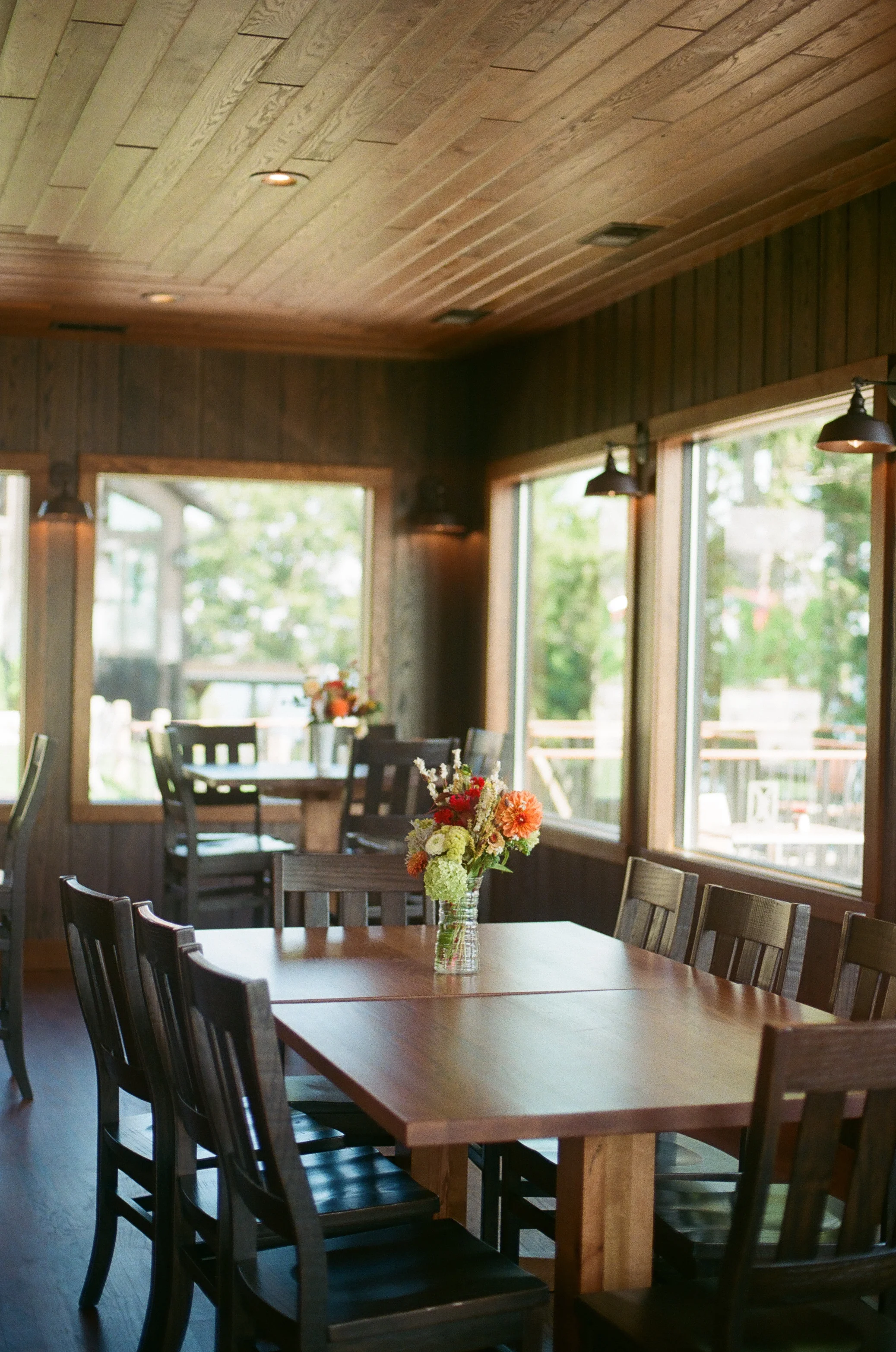 Cozy restaurant interior with wooden decor and floral centerpieces