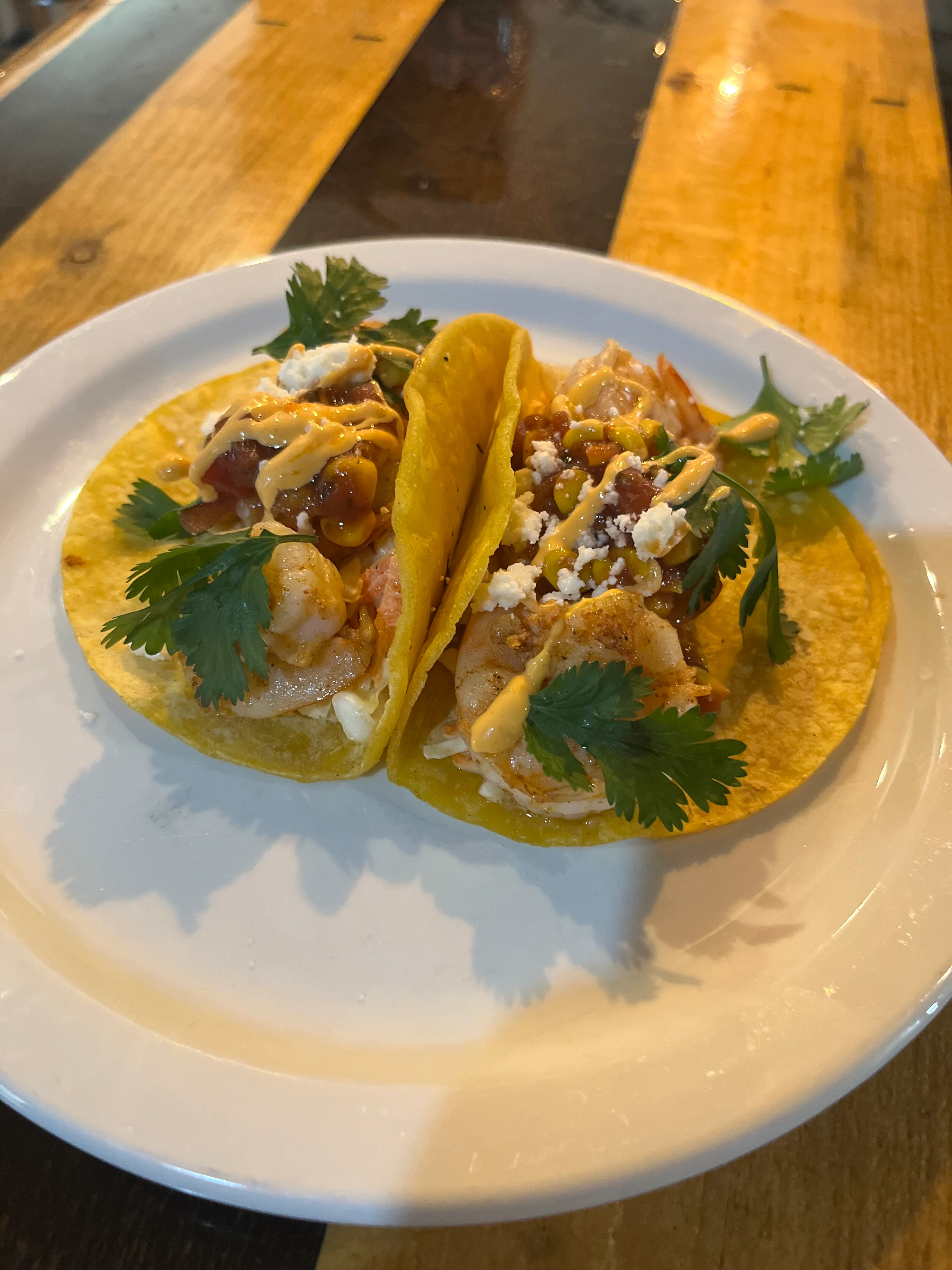 Delicious shrimp tacos topped with cilantro and sauce