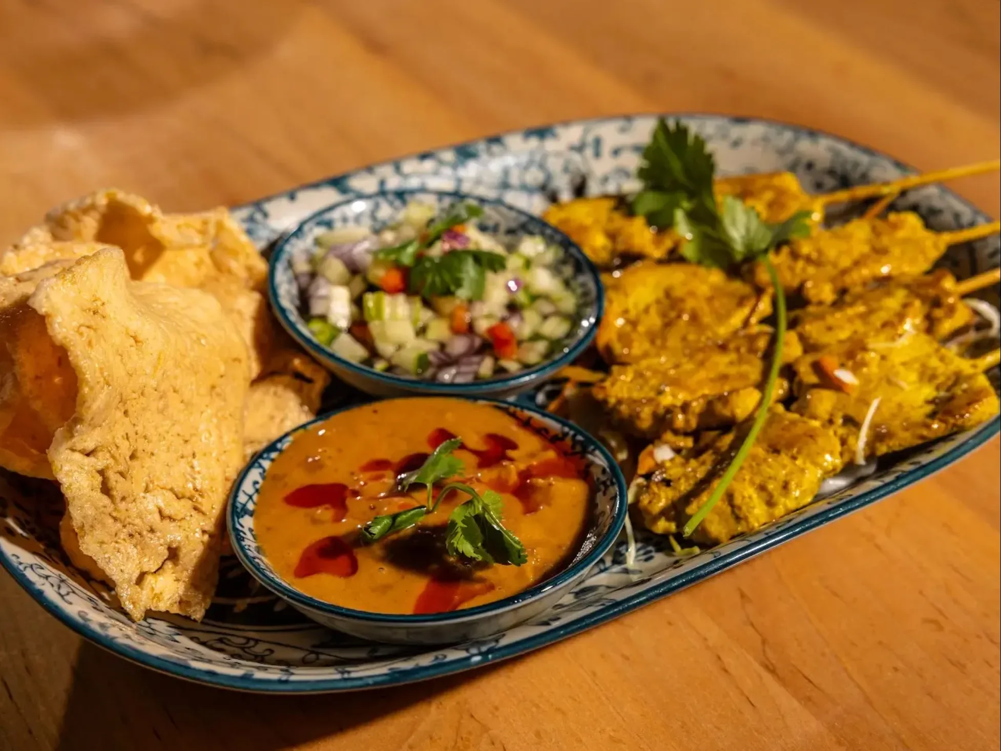 Indonesian satay platter with peanut sauce and fresh salad