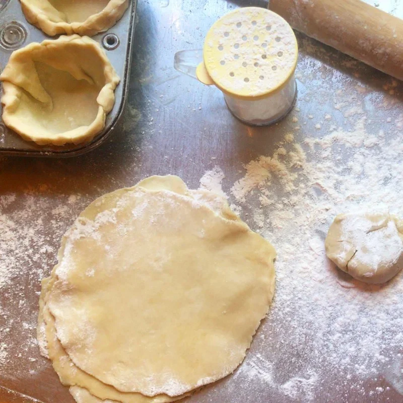 Homemade pie crust preparation on a floured surface