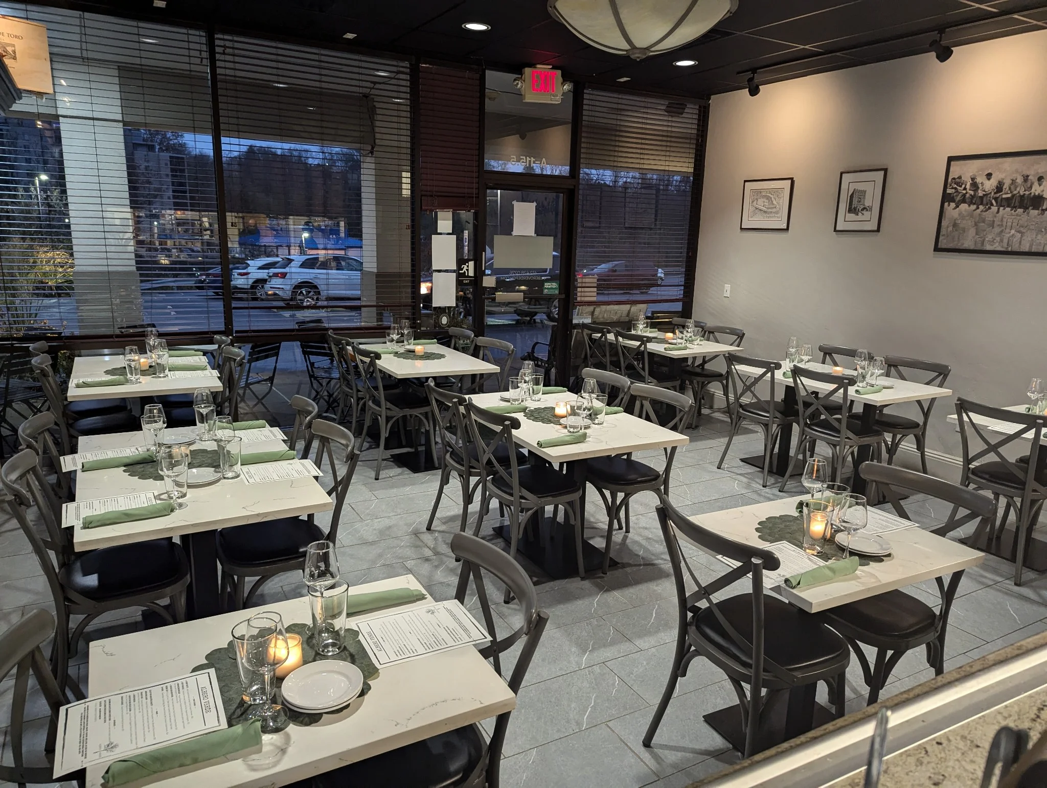 Cozy restaurant interior with tables set for dining and warm lighting.