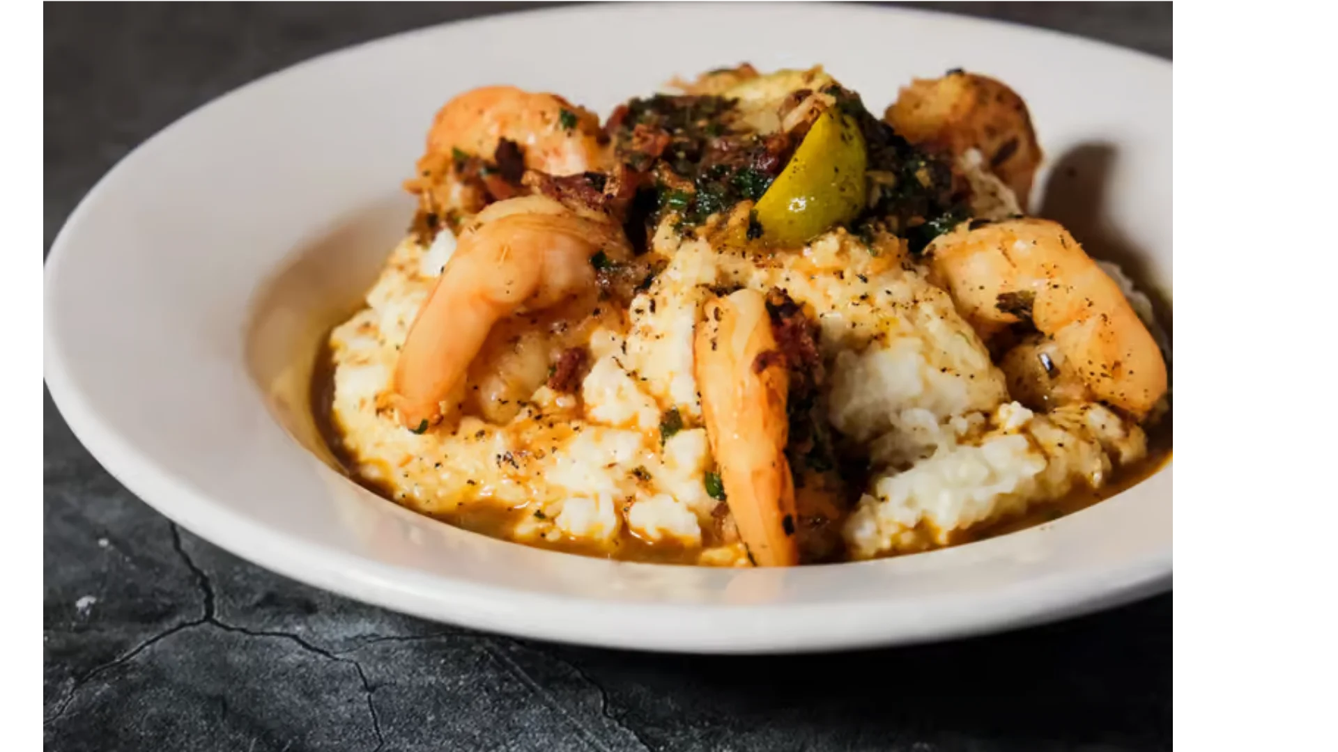 Shrimp and grits, a classic Southern dish served in a white bowl