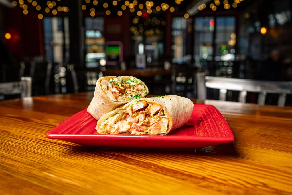 Delicious chicken burritos on a red plate