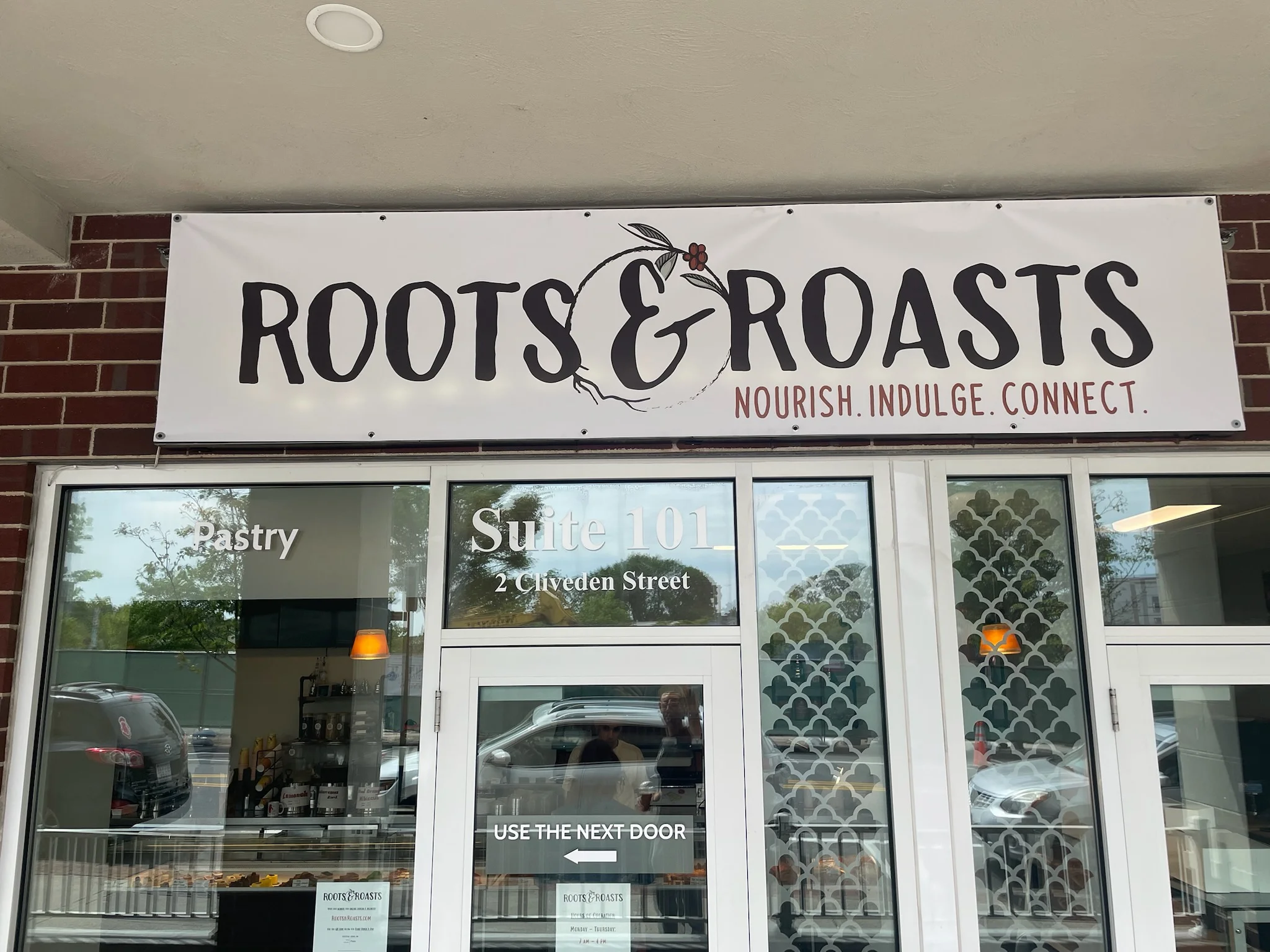Exterior view of Roots & Roasts café with inviting signage
