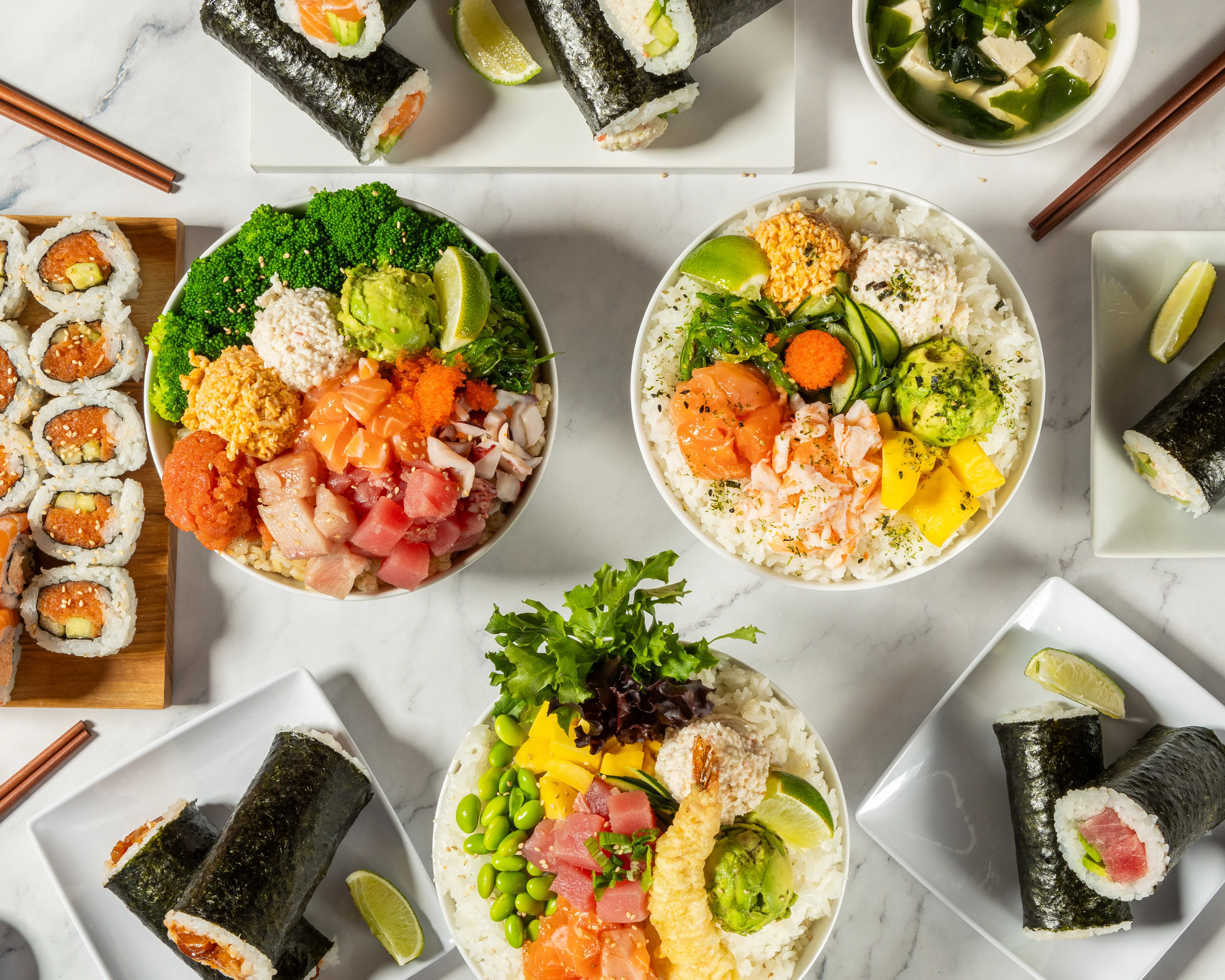 Japanese sushi and sashimi platter with colorful rice bowls