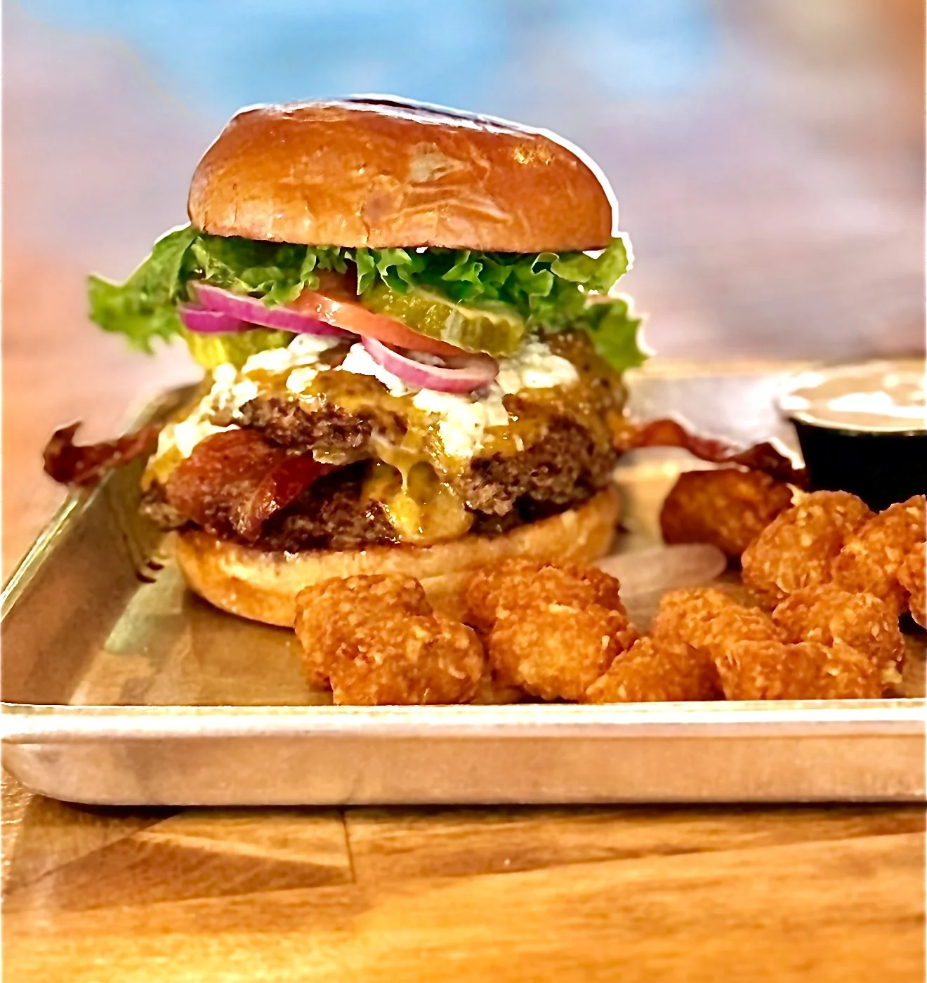 Juicy burger with crispy tots on a plate