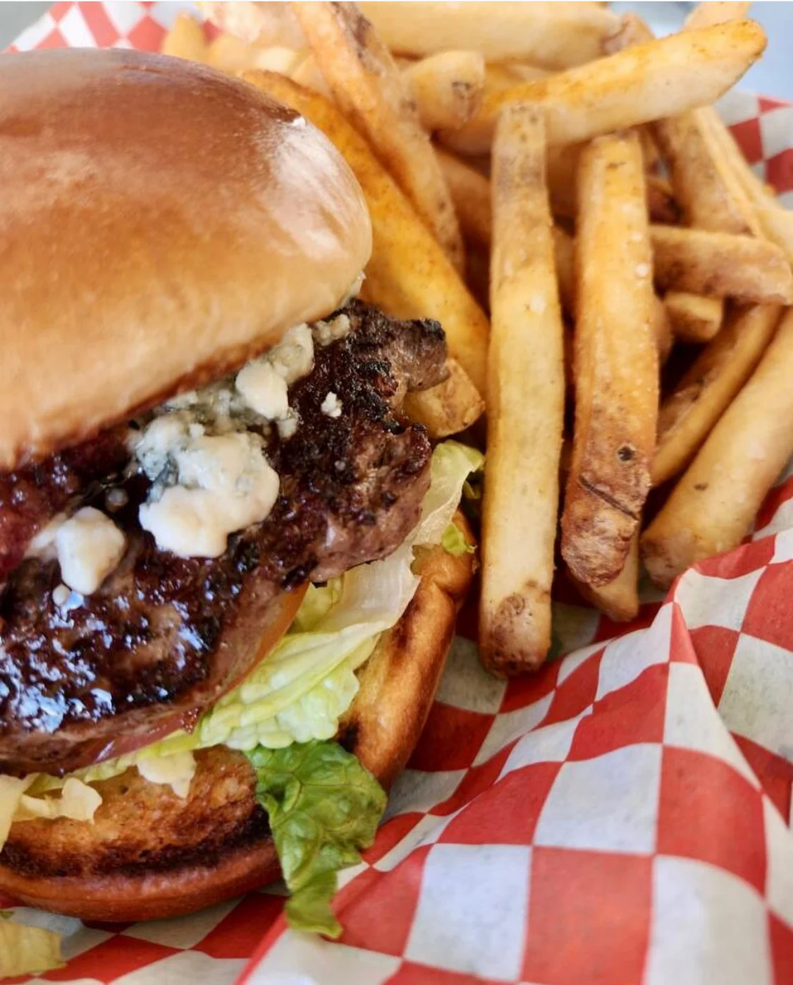 Delicious gourmet burger with fresh toppings on a wooden table