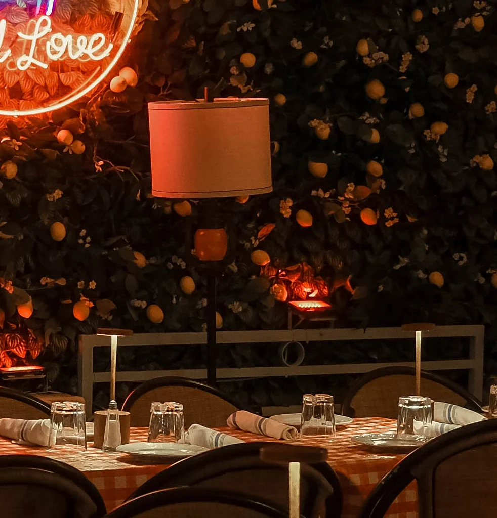 Charming restaurant interior with neon sign and cozy seating