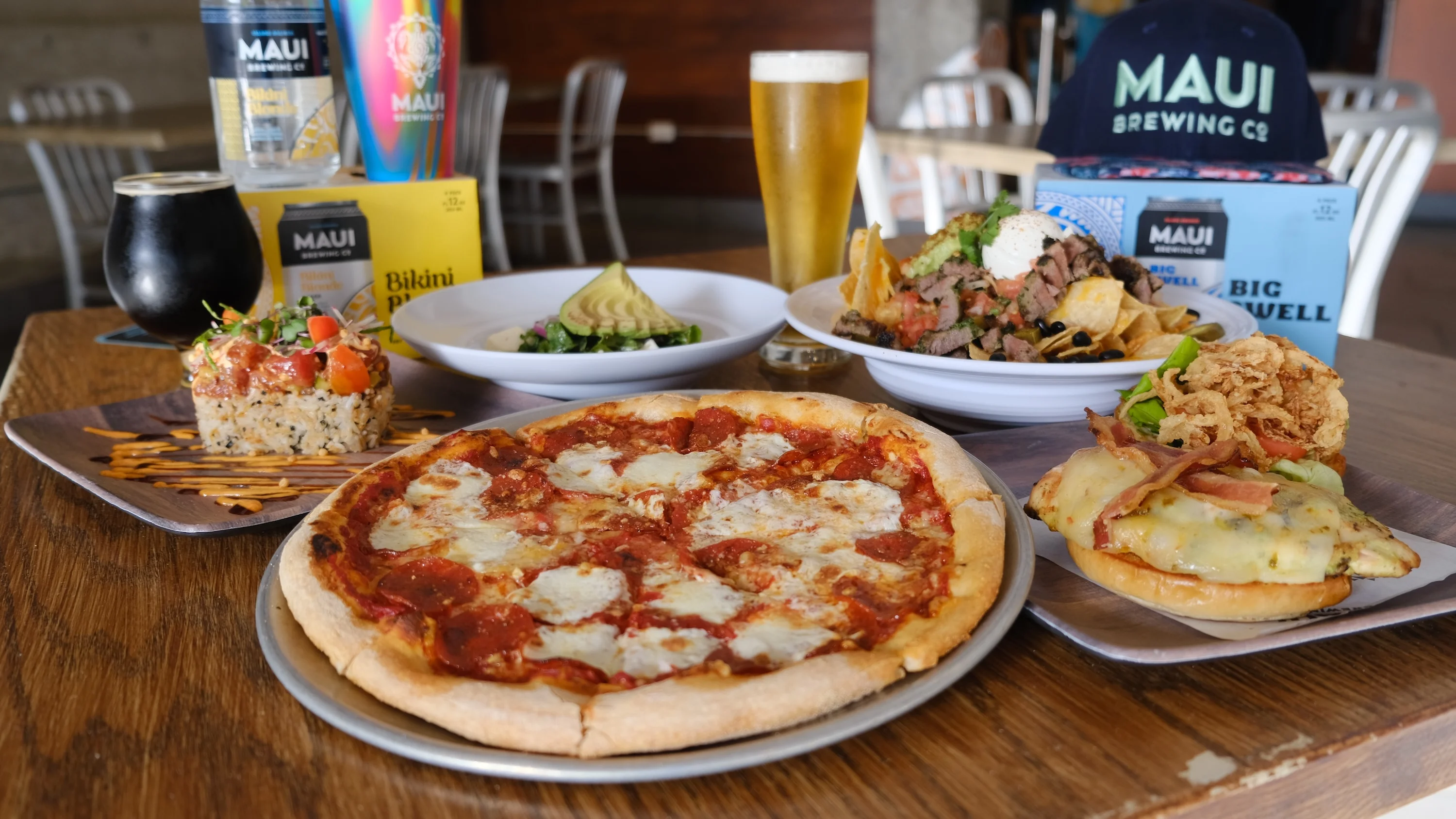 Assorted dishes including pepperoni pizza and nachos in a casual dining setting