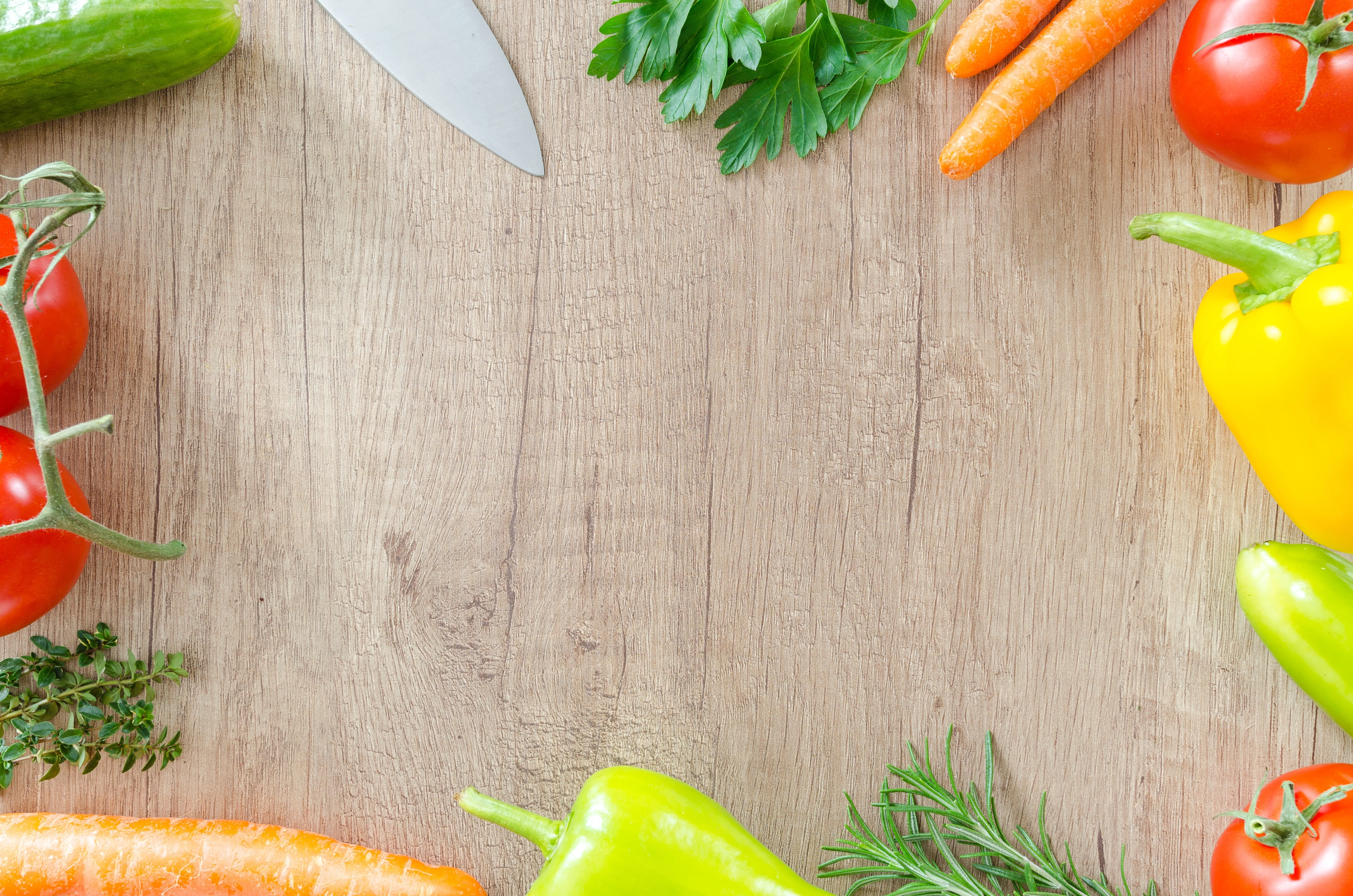 Table with fresh vegetables and a knife