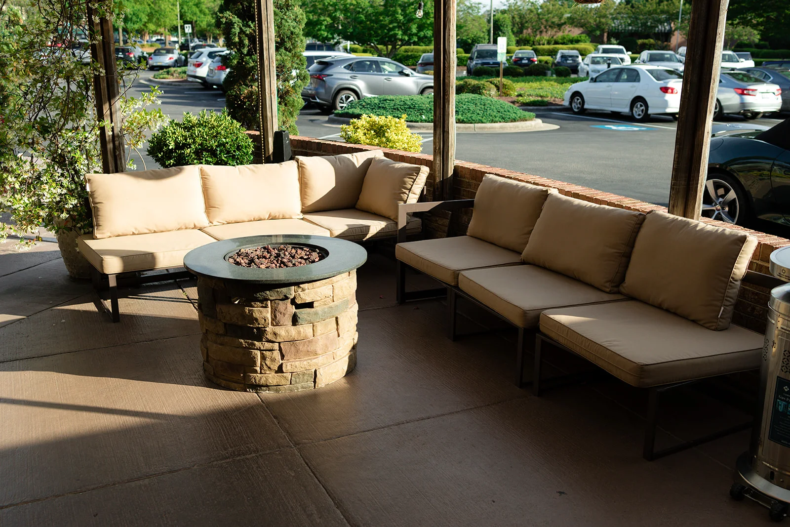 Outdoor seating area with cozy couches and a fire pit