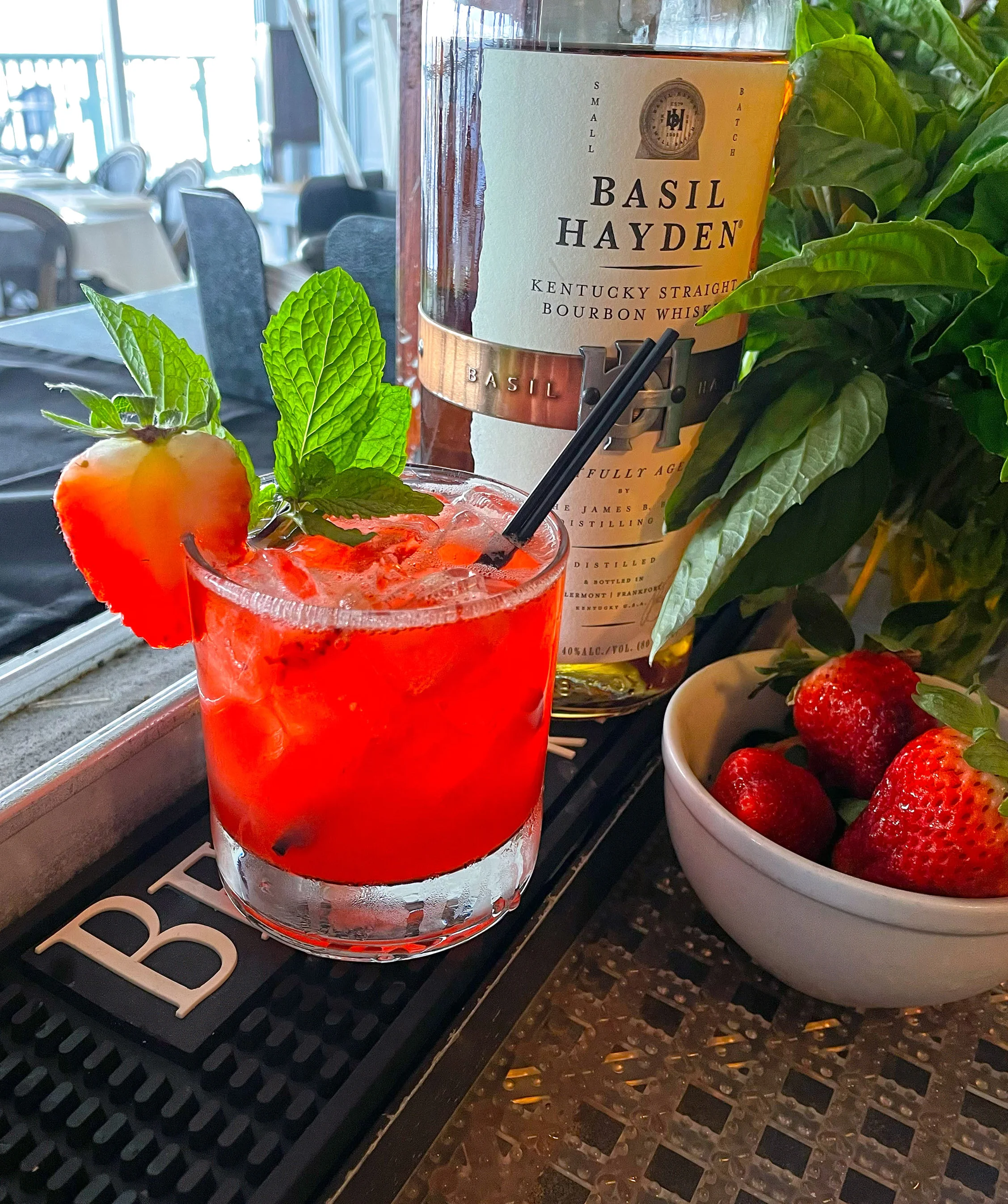 Refreshing cocktail with bourbon, strawberries, and mint