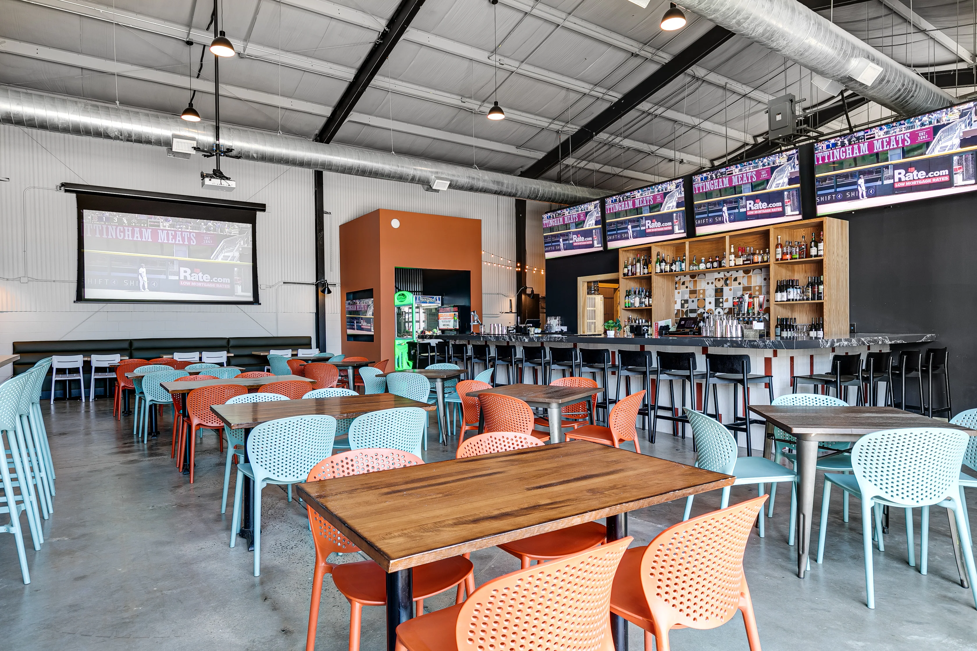 Modern restaurant interior with colorful seating and bar area