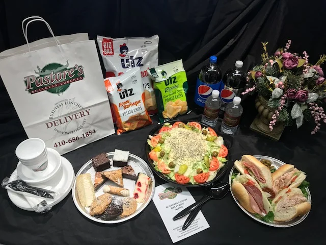 Catering table setup with food and decorations for an event.