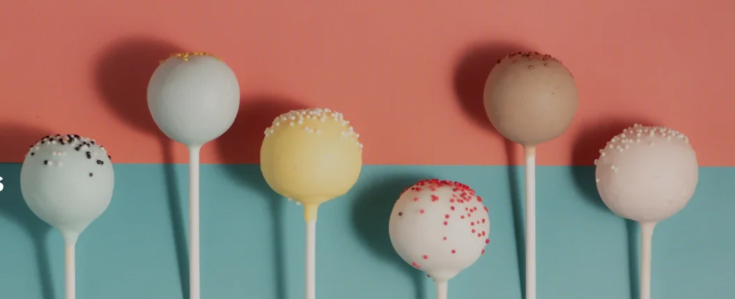 Colorful cake pops arranged on a vibrant background