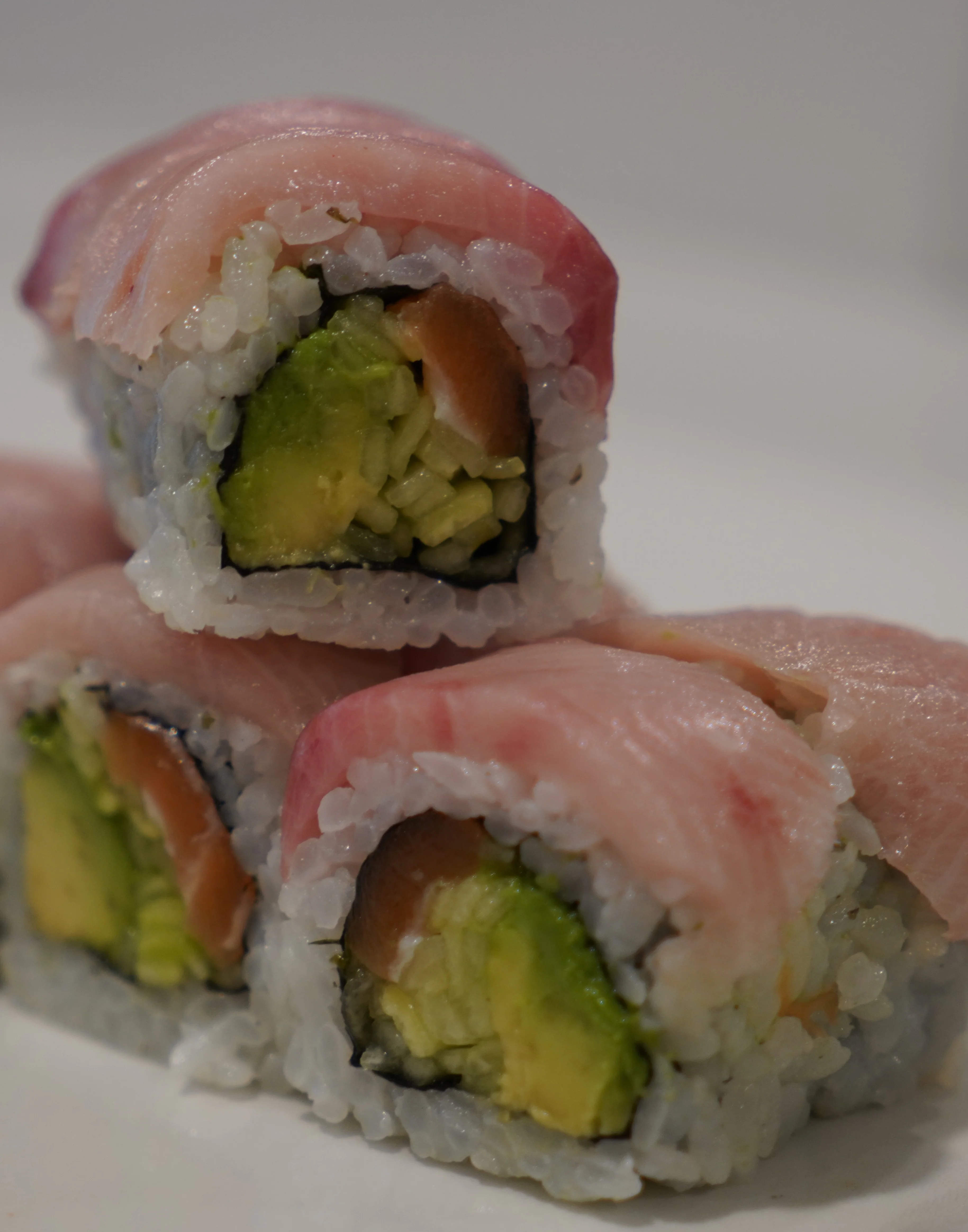 Assorted sushi platter featuring various rolls and sashimi