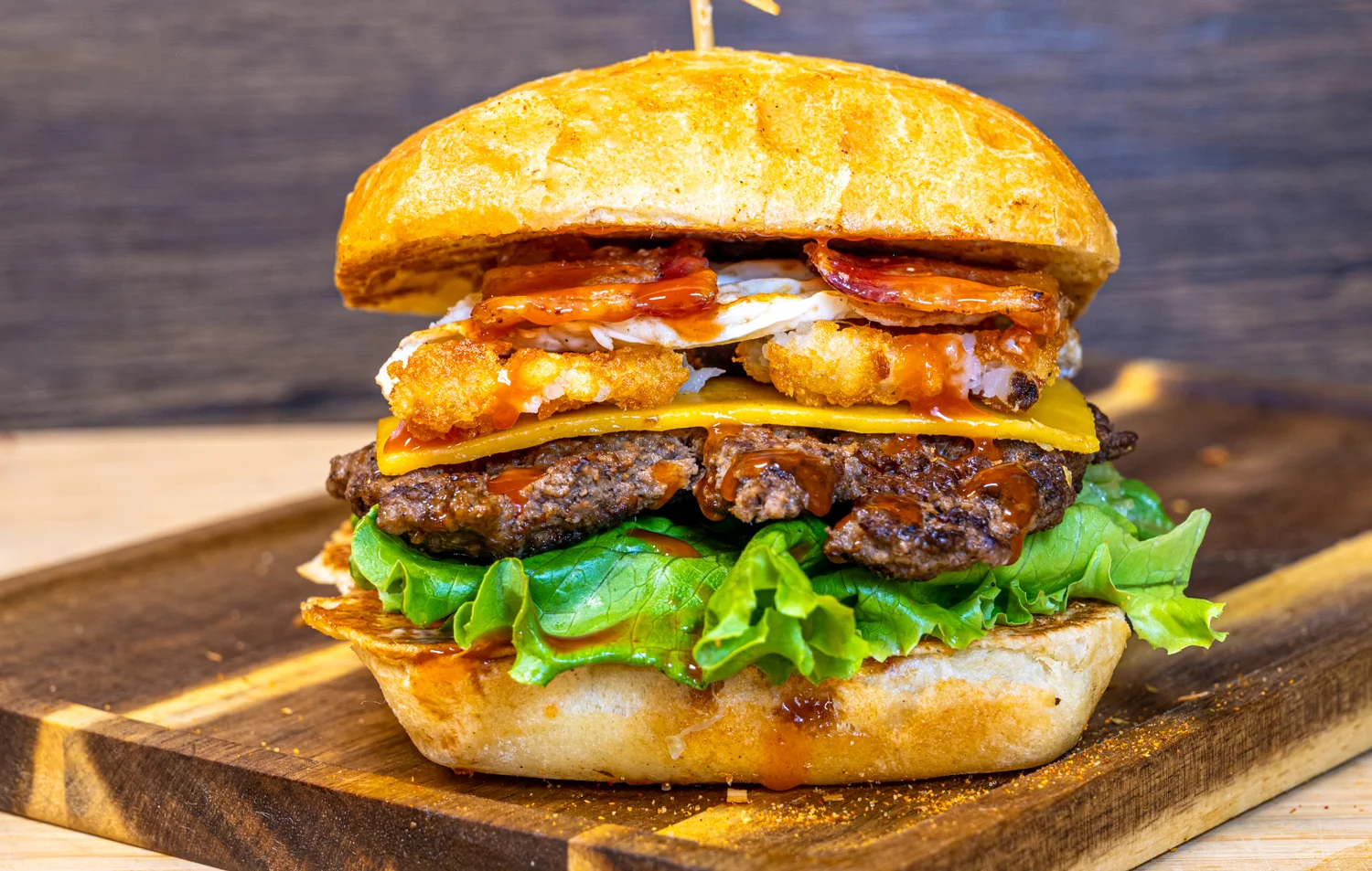 Hearty American cheeseburger stacked with toppings