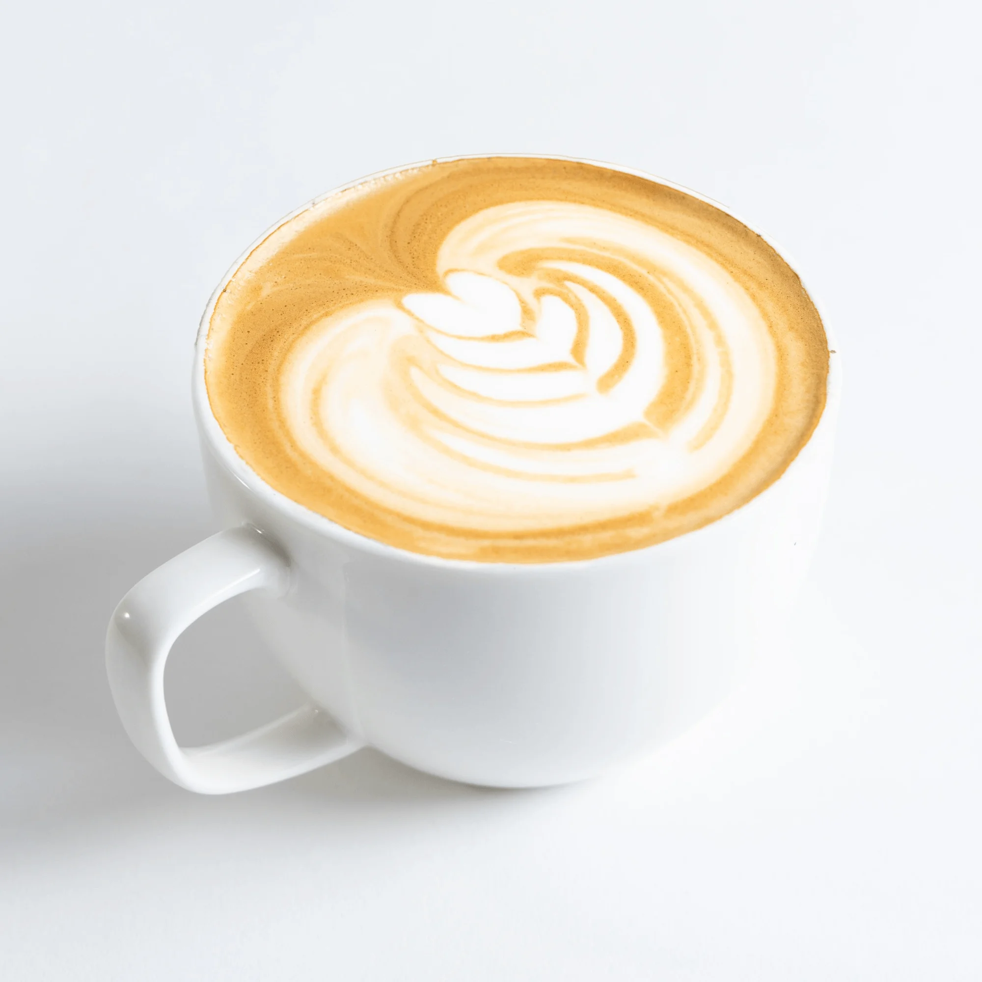 A fresh cup of coffee with a leaf swirl pattern