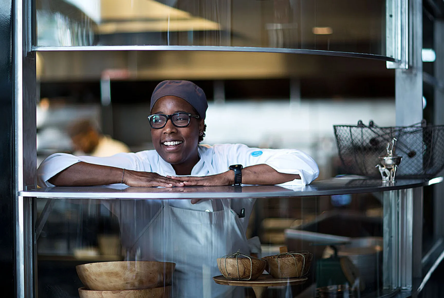 Chef smiling in a modern kitchen setting