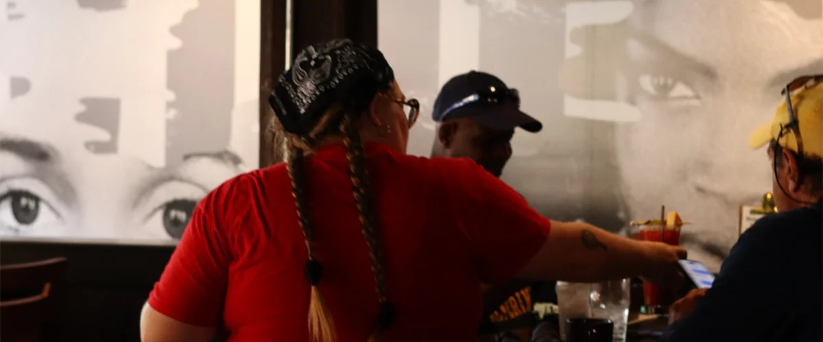 A server at a table on a husker game day