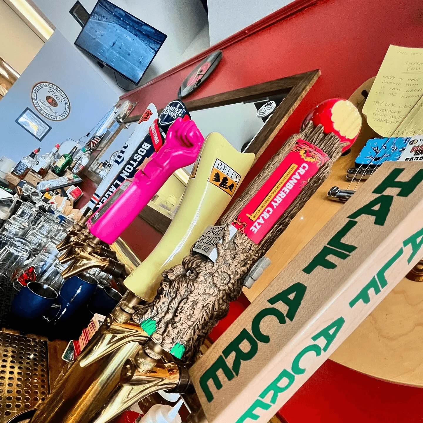 Colorful beer taps at a lively bar counter