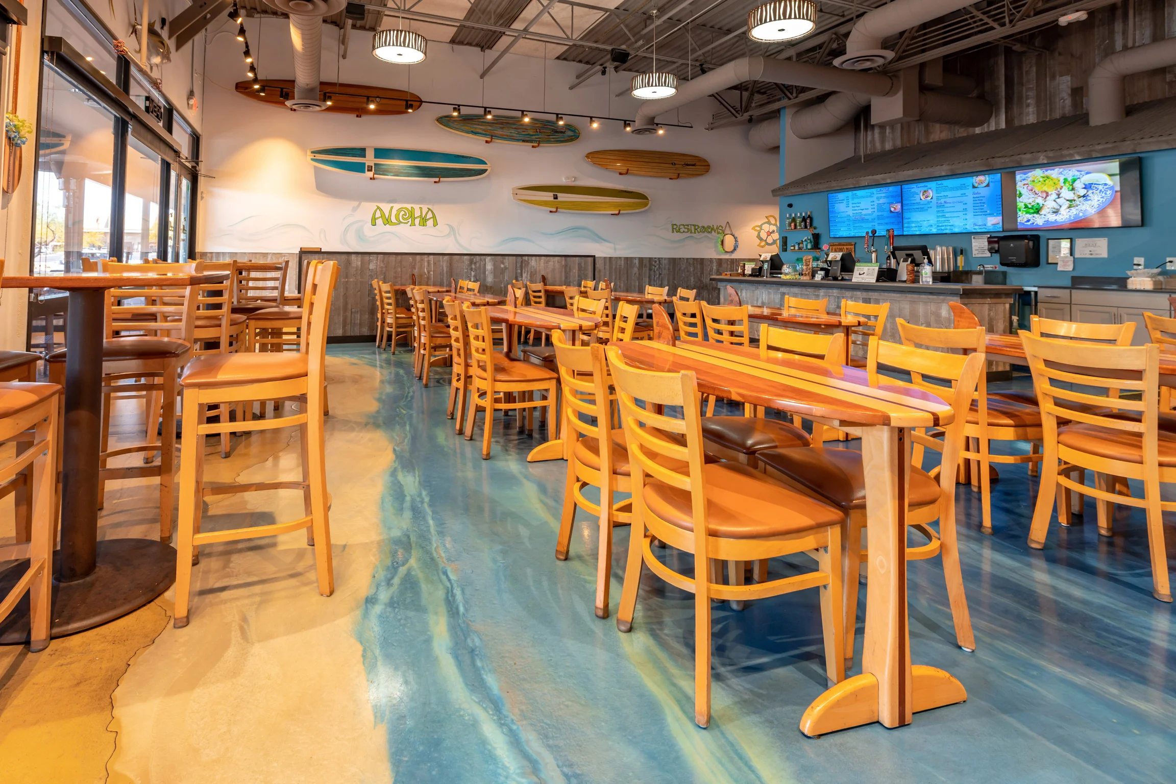 Cozy restaurant interior with surfboard decor and wooden furniture