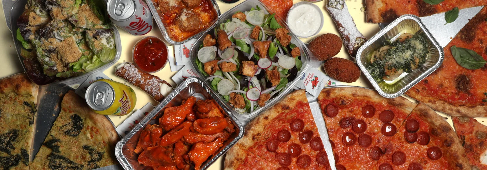 Variety of pizzas and appetizers on a dining table