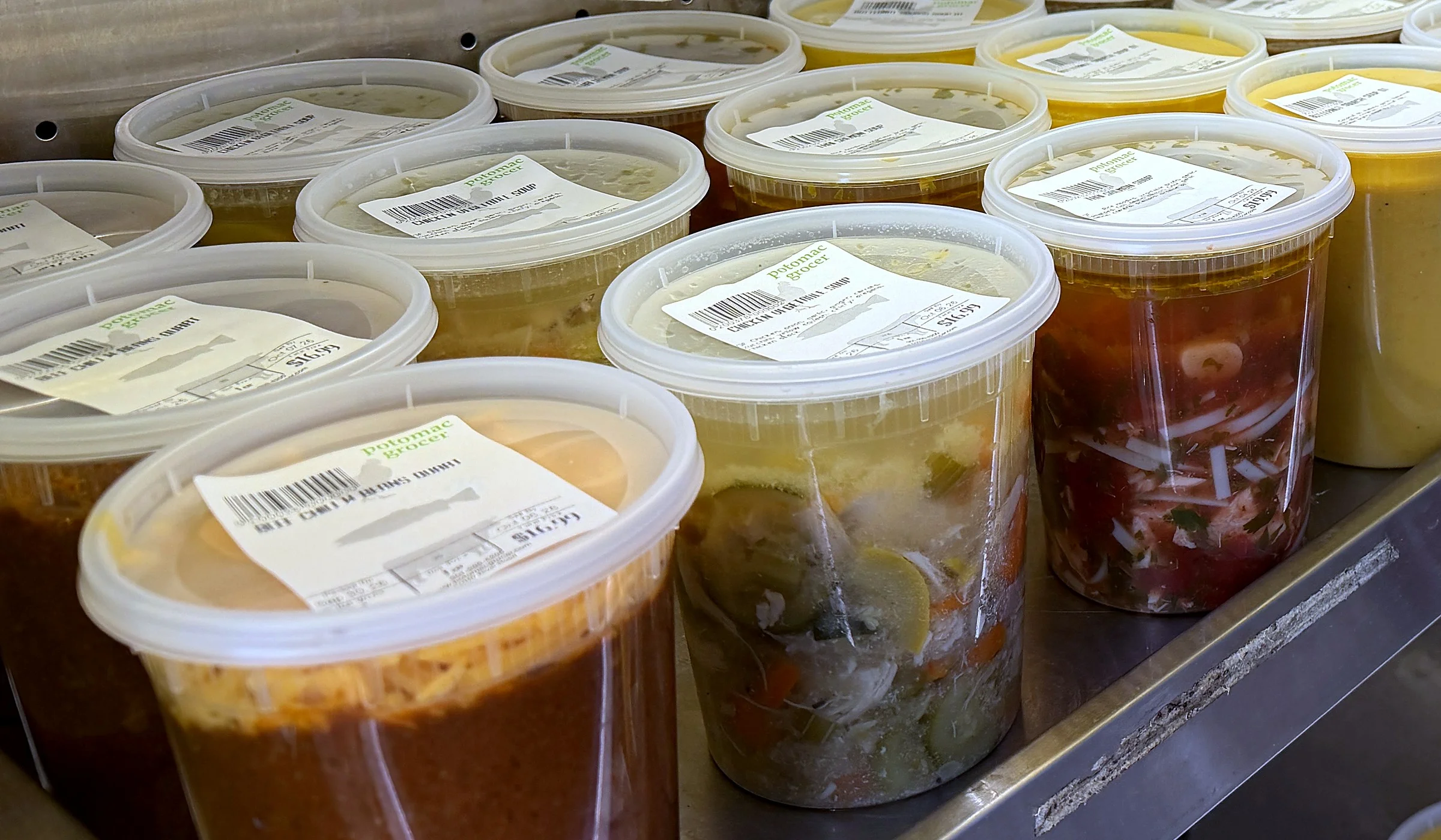 Assorted Mexican soups and salsas in clear deli containers