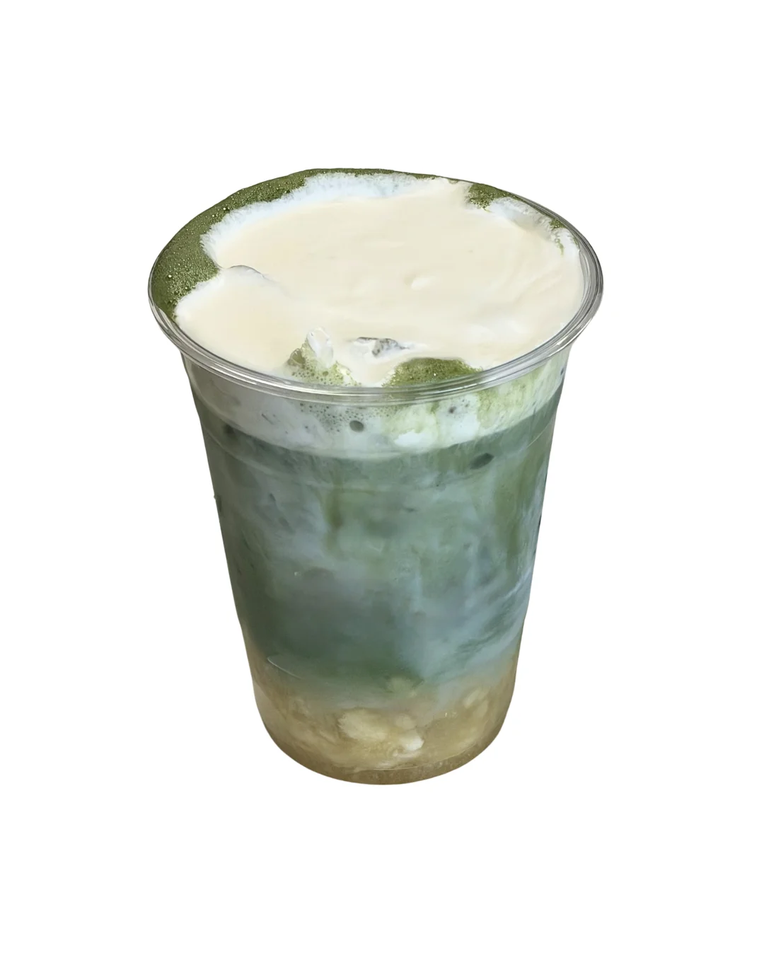 A cup of layered green beverage topped with frothy cream, showcasing a blend of green and beige colors.