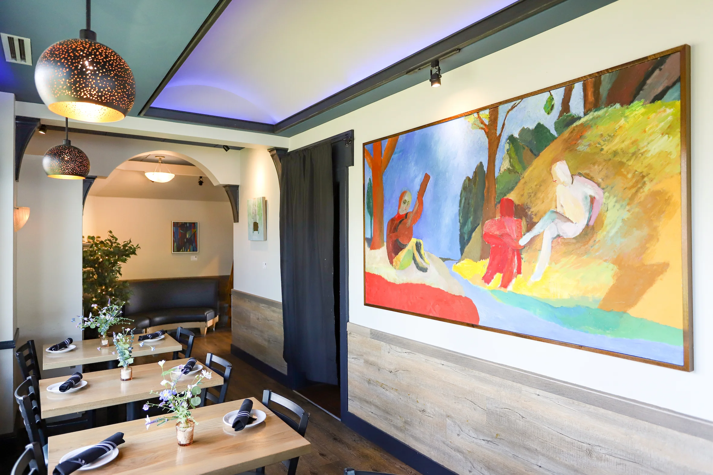 Cozy restaurant interior with colorful artwork and modern decor
