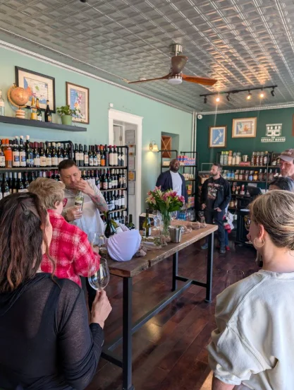 Bartender serving drinks at a vibrant wine shop event