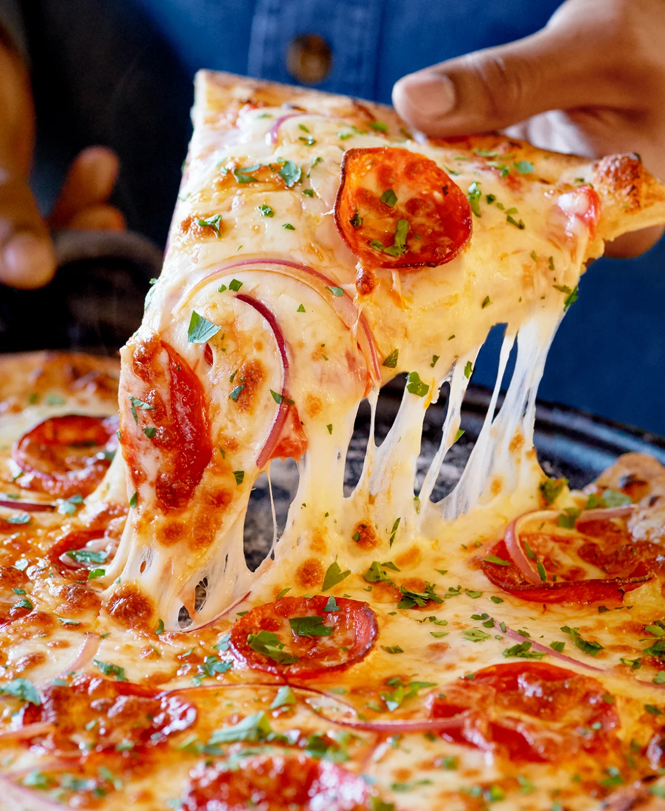 Cheesy pepperoni pizza with fresh herbs