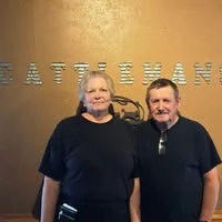 Friendly restaurant staff posing in front of the Cattleman's sign