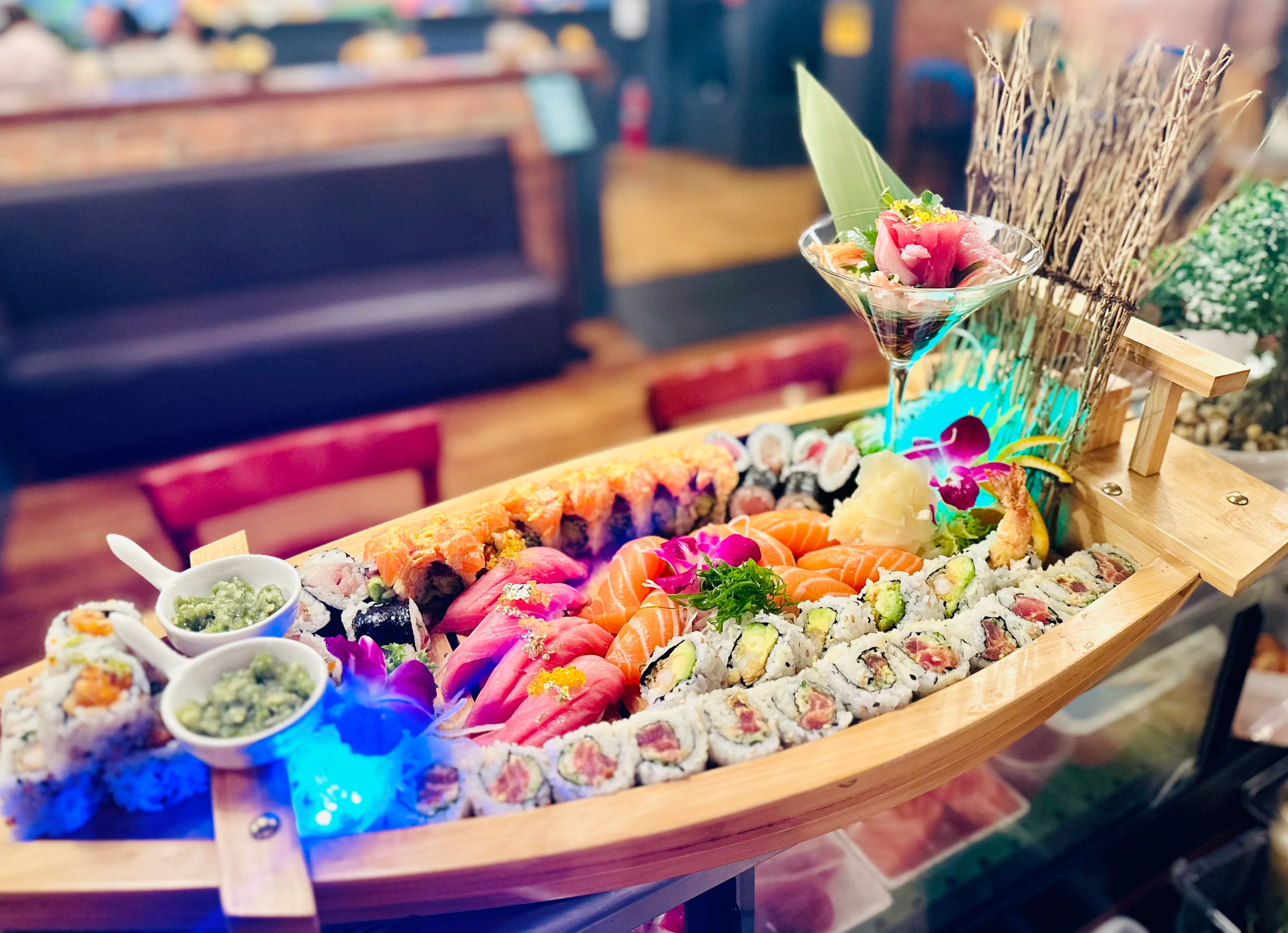Sushi boat platter featuring assorted Japanese sushi and sashimi