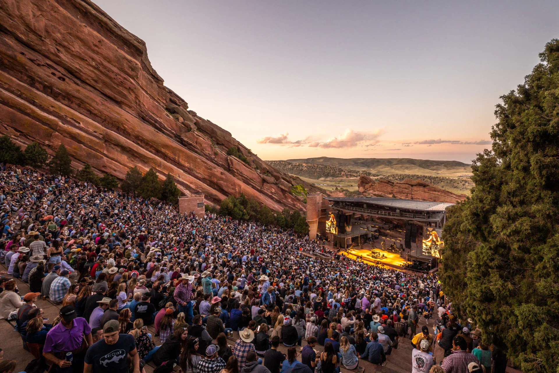 Crowd enjoying a concert at Red Rocks Amphitheatre during sunset