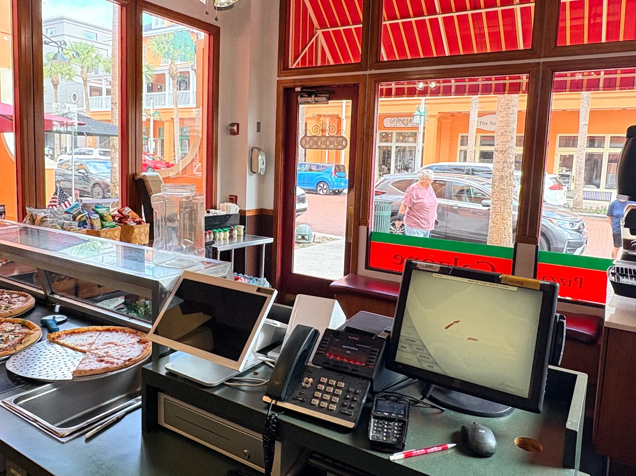 Pizza counter in a vibrant restaurant with fresh pies