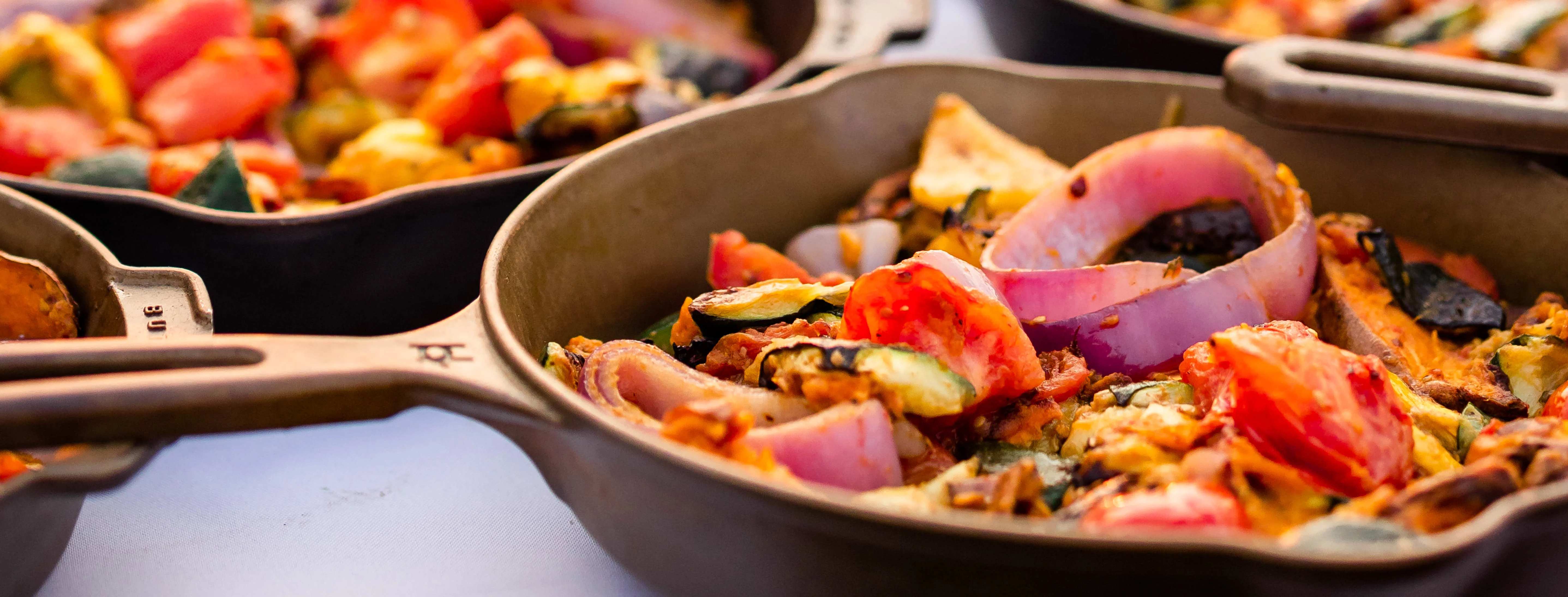 Colorful Mediterranean vegetable paella at sunset