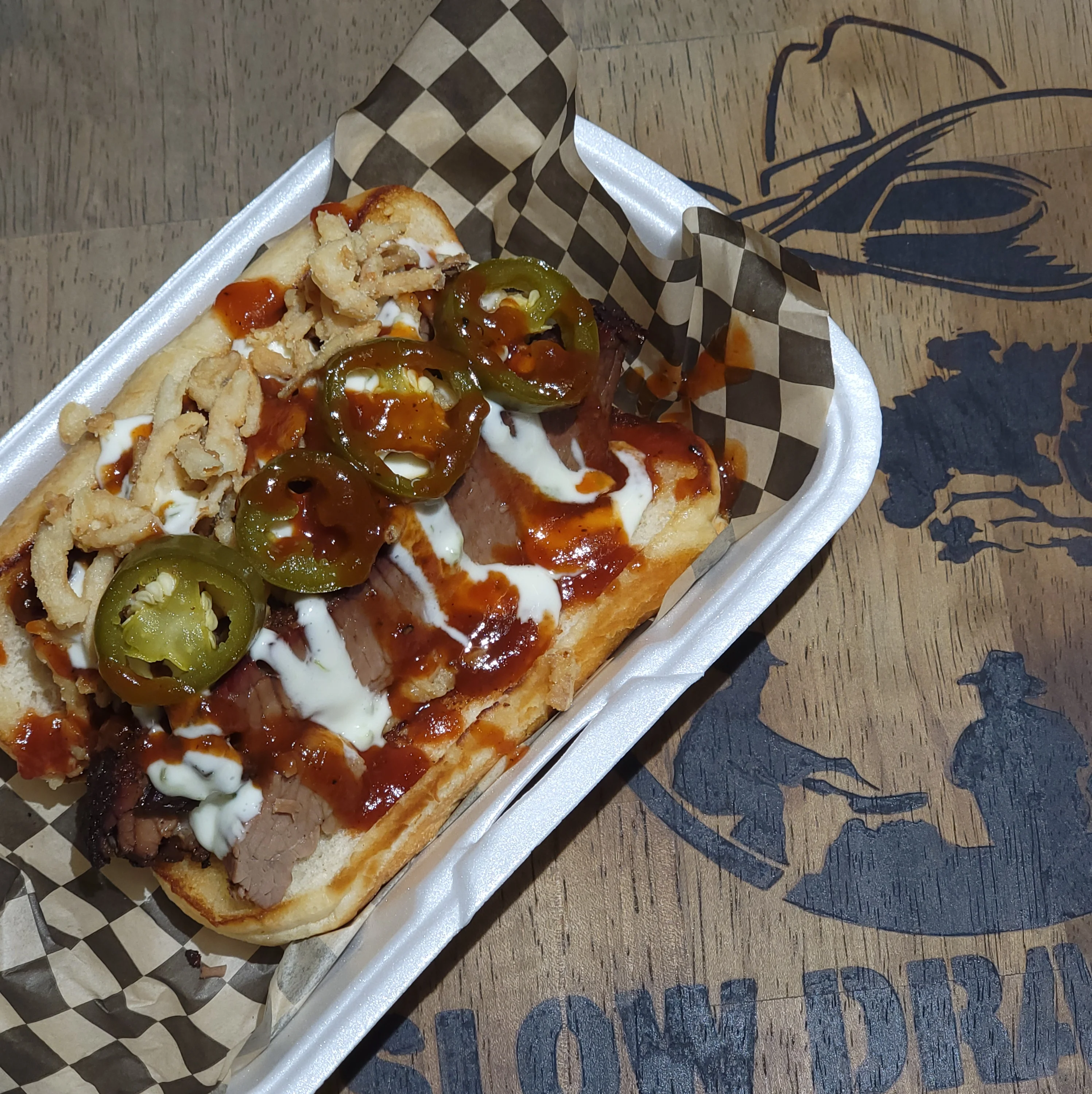 Texas-style brisket hot dog with jalapeños and barbecue sauce