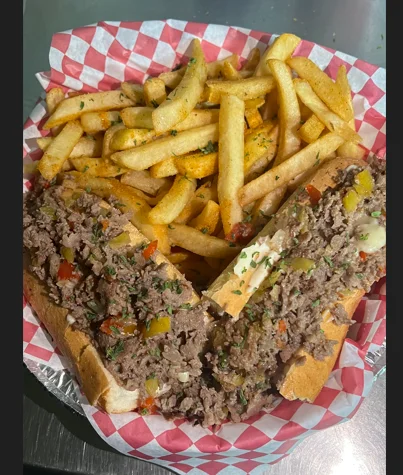 Philly cheesesteak sandwich with crispy fries