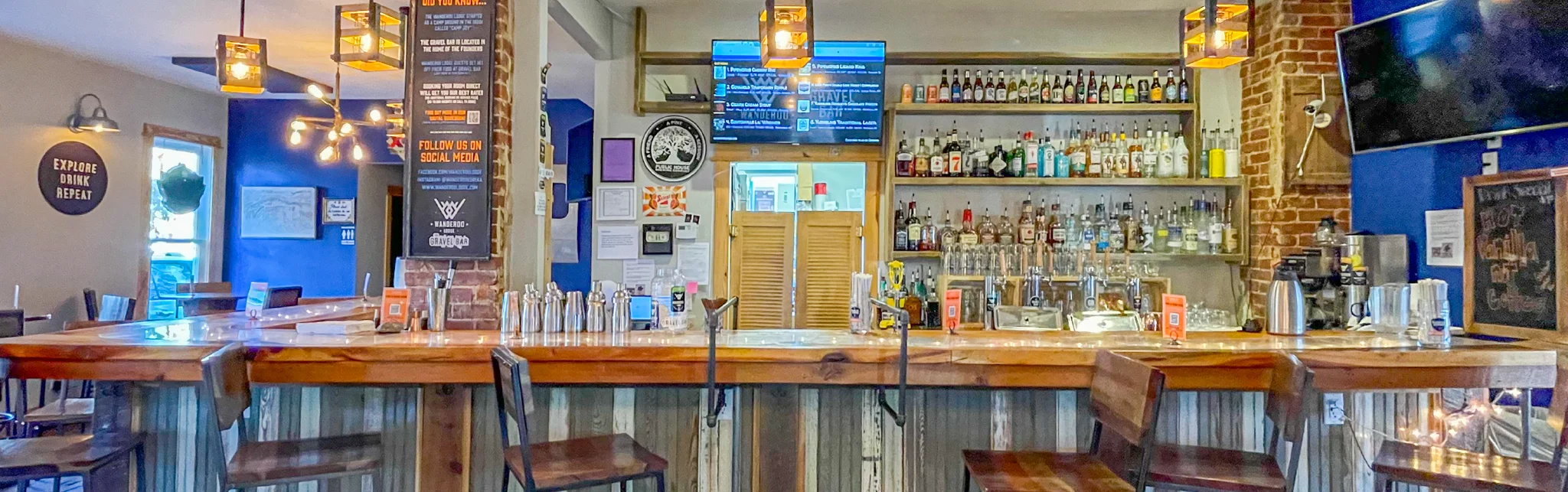 Cozy bar interior with rustic decor and a well-stocked liquor shelf