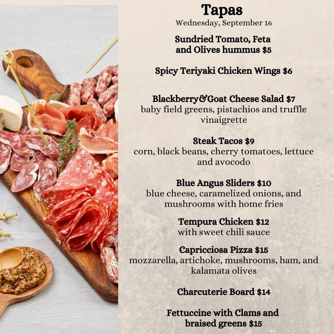 Assorted tapas platter featuring charcuterie and gourmet small plates