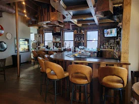 Cozy restaurant bar interior with warm lighting and wooden accents