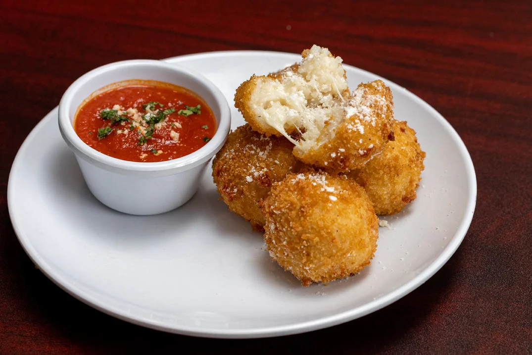 Crispy Italian arancini served with marinara sauce