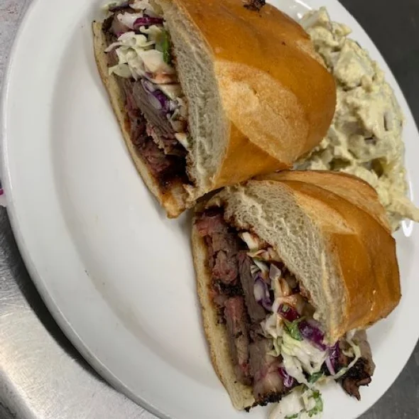 Smoked brisket sandwich with coleslaw on a toasted bun