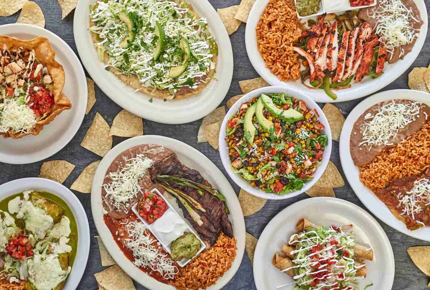 Colorful Mexican platter with tacos, rice, and fresh toppings