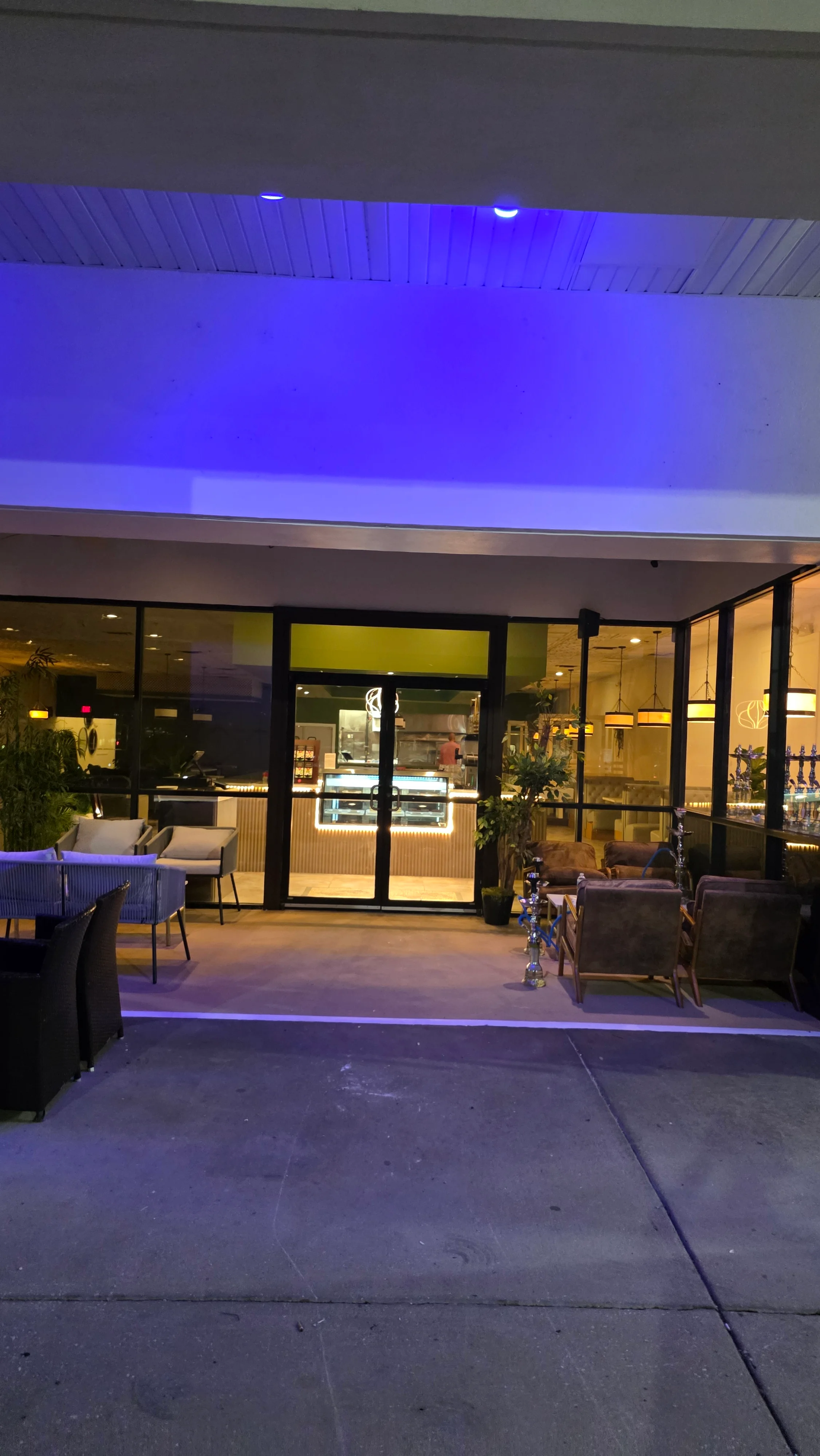 Modern restaurant entrance with stylish seating and ambient lighting