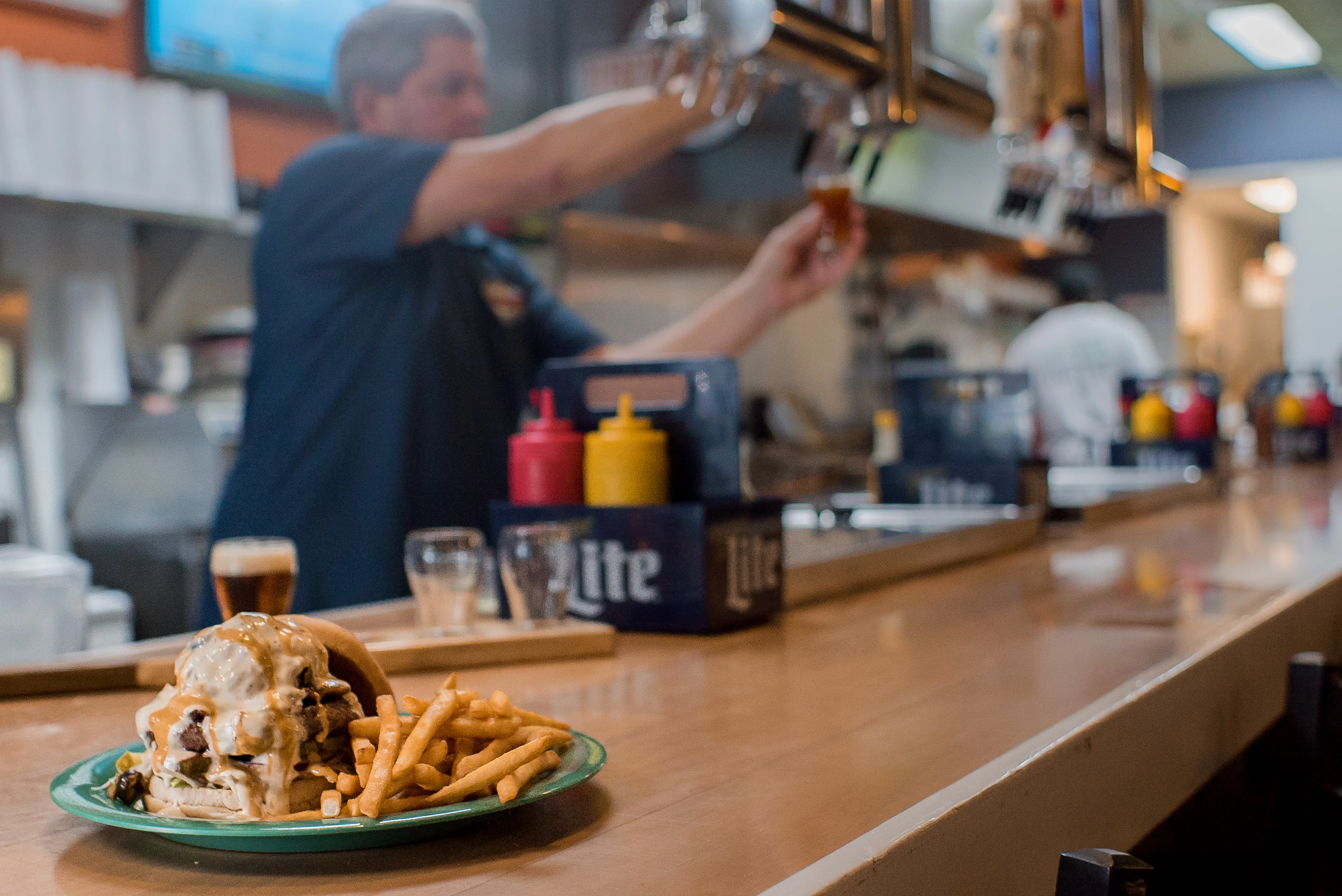 Juicy cheeseburger with fries in a casual bar setting