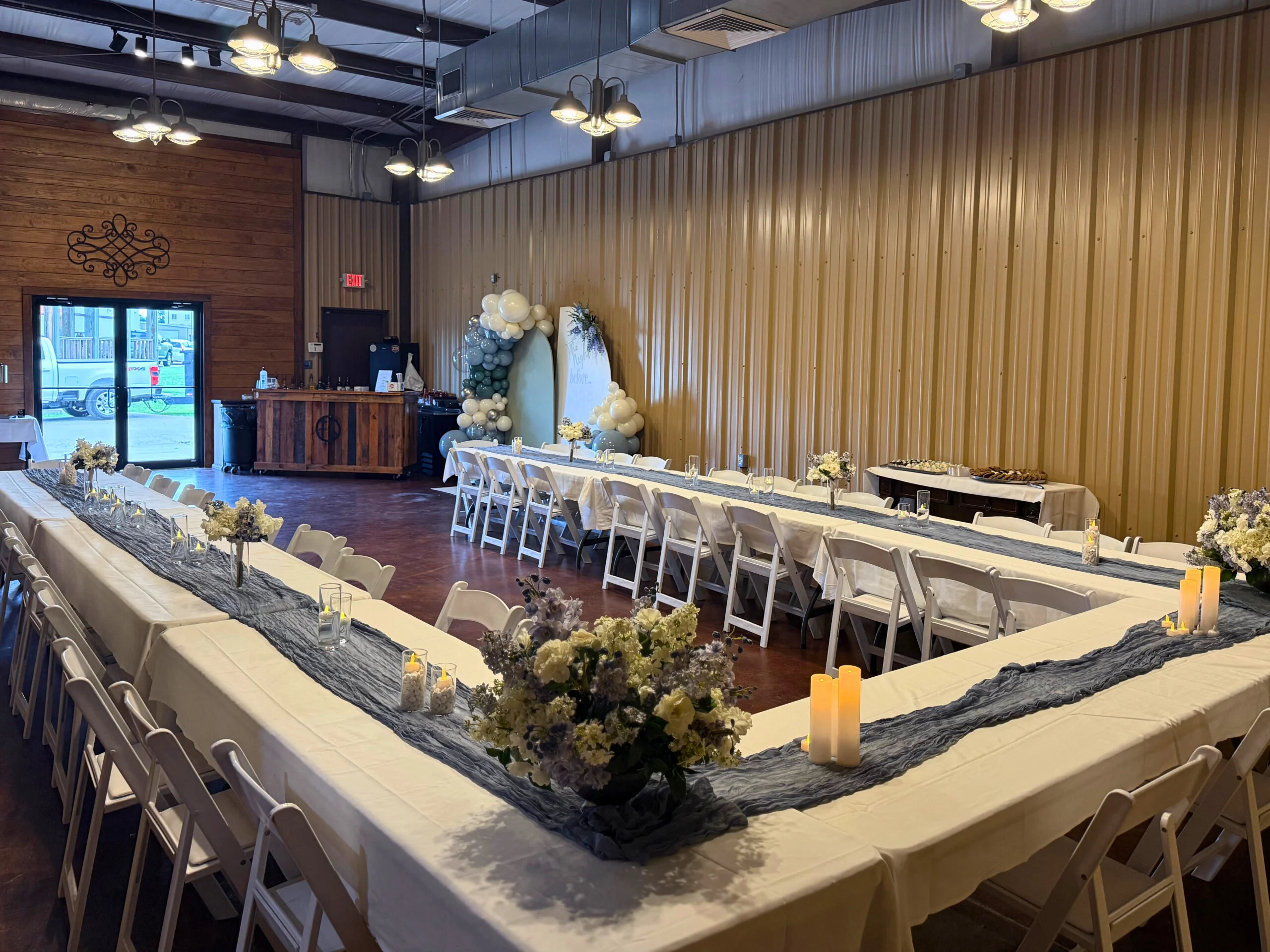 Elegant event space with long tables and floral centerpieces